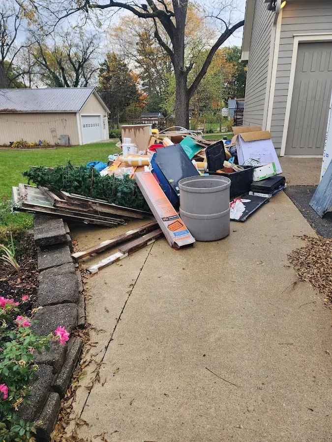 Dumpster being loaded with debris for 3 Yard Dumpster Rental in Albia